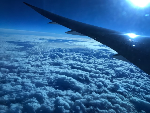 Plane wing and clouds